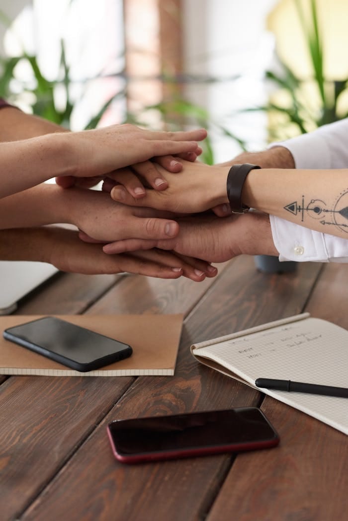 Hands from a diverse team